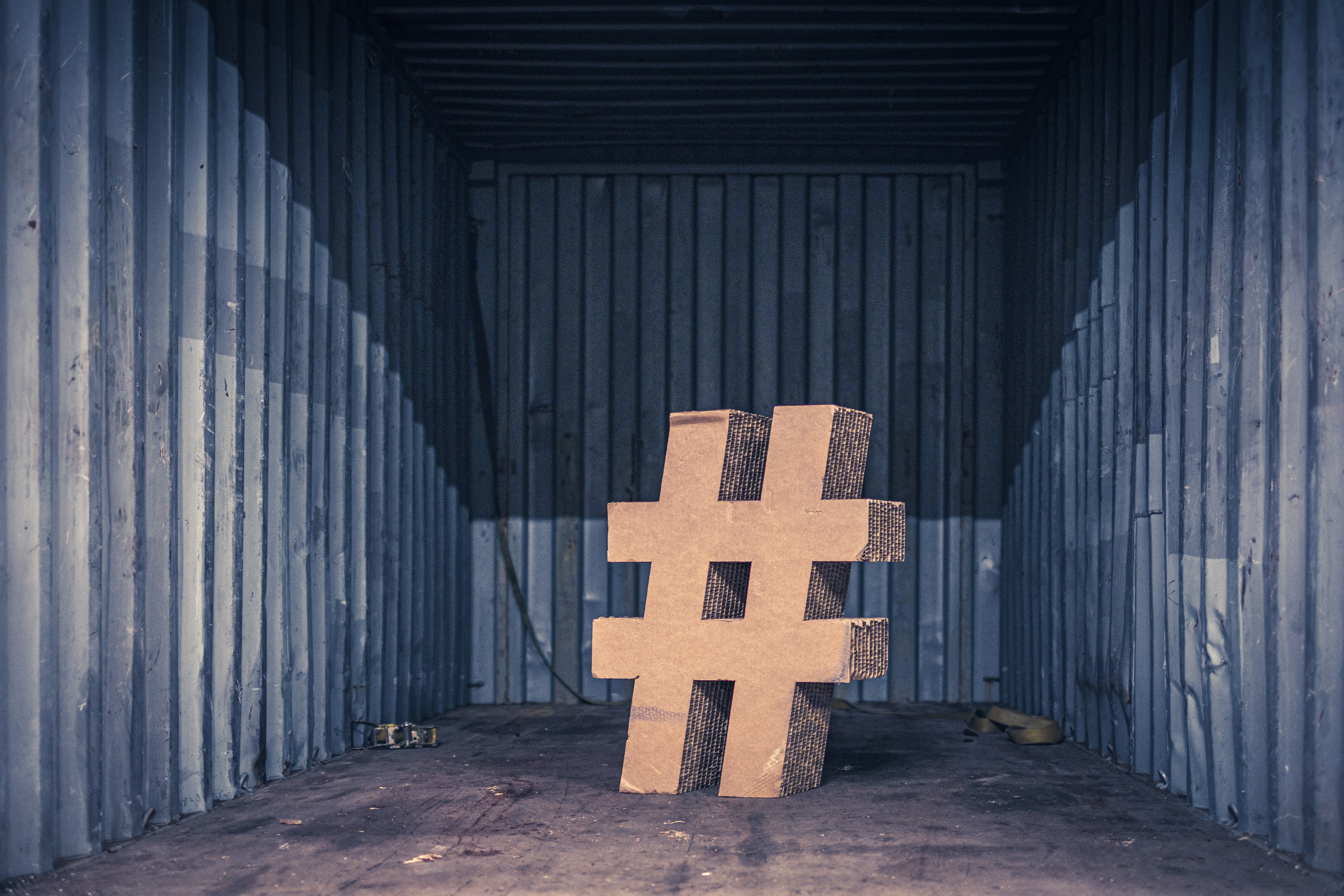 Carboard cutout of hashtag symbol in a shipping container